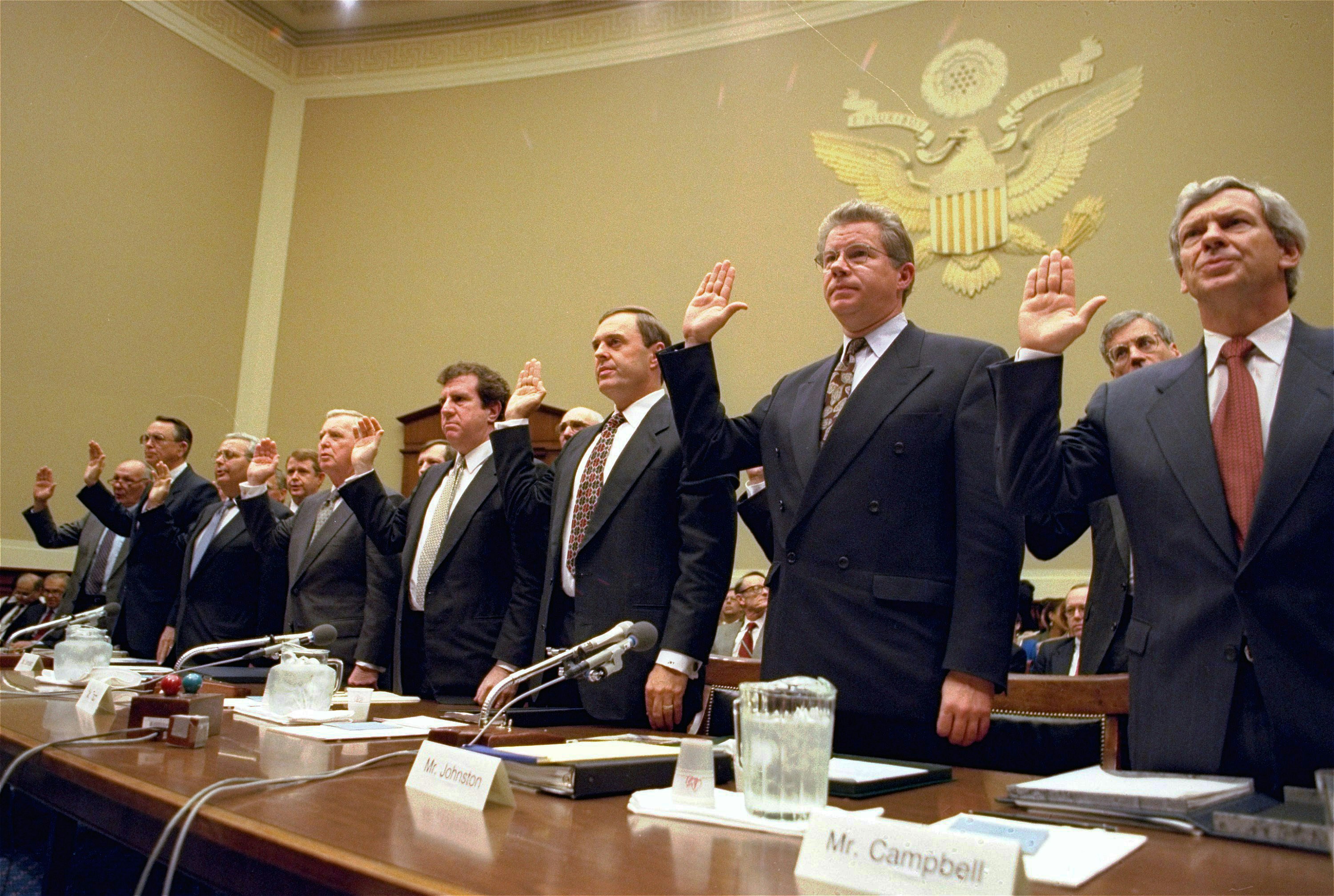 FILE - In this Thursday, April 14, 1994 file photo, the heads of the nation's largest cigarette companies are sworn in before a hearing of a House Energy subcommittee which was holding hearings on the contents of cigarettes on Capitol Hill in Washington. More than 40 states brought lawsuits demanding compensation for the costs of treating smoking-related illnesses. Big Tobacco settled in 1998 by agreeing to pay about $200 billion and curtail marketing of cigarettes to youths. From left are Robert Sprinkle III, executive vice president for Research American Tobacco Co.; Donald Johnston, American Tobacco; Thomas Sandefur Jr., Brown and Williamson Tobacco Corp.; Edward Horrigan Jr., Liggett Group Inc.; Andrews Tisch, Lorillard Tobacco Co.; Joseph Taddeo, U.S. Tobacco Co.; James Johnston, RJ Reynolds; and William Campbell, Phillip Morris USA. (AP Photo/John Duricka)