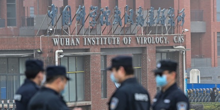 Security personnel stand guard outside the Wuhan Institute of Virology in Wuhan on February 3, 2021.