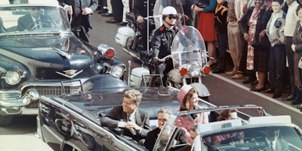 President John F. Kennedy and First Lady Jackie Kennedy smile at the crowds lining their motorcade route in Dallas on Nov. 22, 1963, just minutes before the president was assassinated.