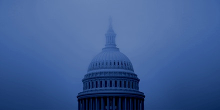 The dome of U.S. Capitol building shrouded in fog. Photographer: Al Drago/Bloomberg