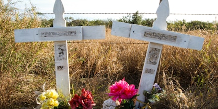 Two white crosses memorialize Marcos Castro Estrada and Jose Leonardo Coj Cumar, who were fatally shot on the Texas-Mexico border. Photographed in 2014, the crosses at the scene of the killing have since been removed.