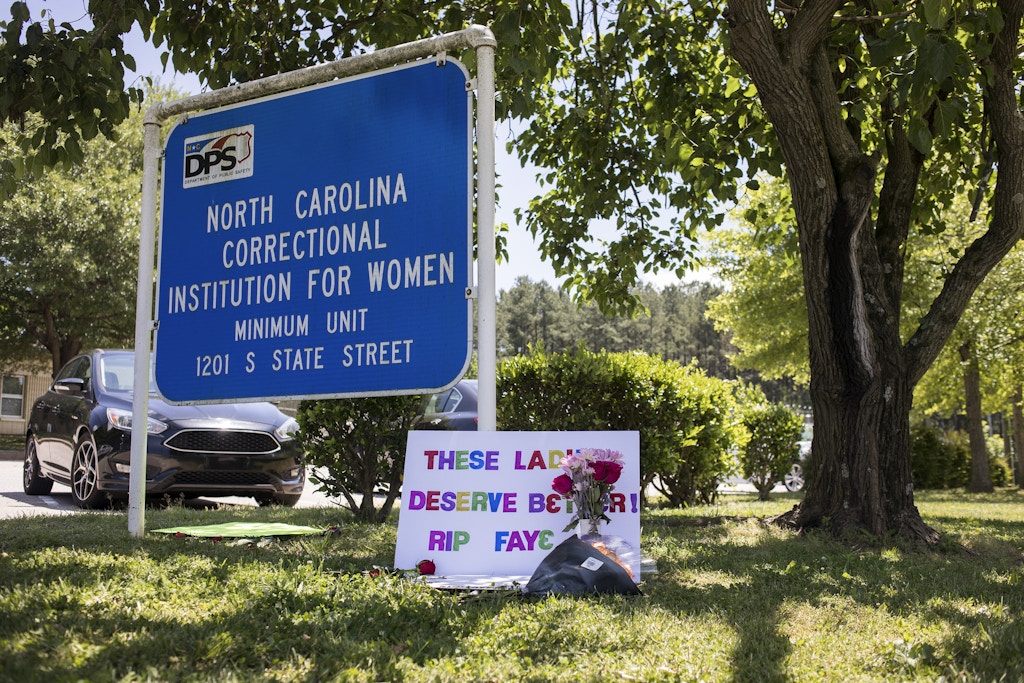 A sign and flowers, seen here on Saturday, May 9, 2020, sit in front of the N.C. Correctional Institution for Women sign in memory of Faye Brown, a 67-year-old inmate who died of COVID-19 complications there on Wednesday, May 6. (Julia Wall/Raleigh News & Observer/Tribune News Service via Getty Images)