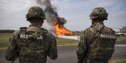 Mexican marines observe the burning of kilos of cocaine that were seized in the port city of Veracruz, Mexico, on January, 16, 2018.Navy, Federal and Criminal Investigation Agency authorities witnessed the incineration of the drug - valued at five million dollars. / AFP PHOTO / VICTORIA RAZO        (Photo credit should read VICTORIA RAZO/AFP via Getty Images)