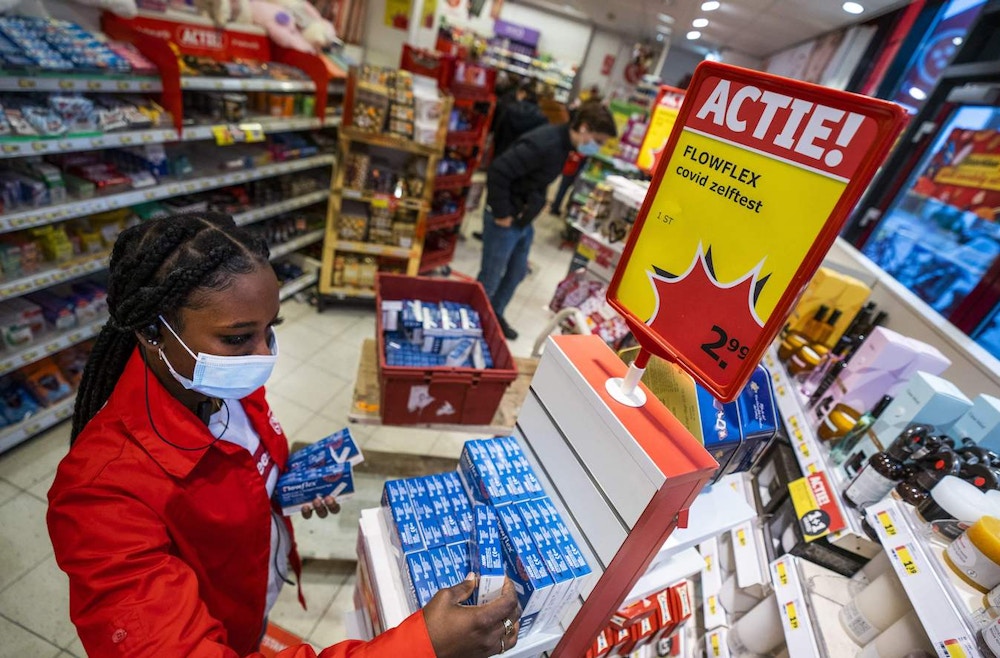 An employee arranges self-tests for the coronavirus (Covid-19) on the shelves of a drugstore in Utrecht, on November 30, 2021. - The tests were sold out in many stores and online and had to be replenished.  - Netherlands OUT (Photo by Jeroen JUMELET / ANP / AFP) / Netherlands OUT (Photo by JEROEN JUMELET/ANP/AFP via Getty Images)