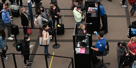 DENVER, COLORADO - NOVEMBER 24: Travelers make their way through TSA security at Denver International Airport the day before Thanksgiving on November 24, 2021 in Denver, Colorado. (Photo by RJ Sangosti/MediaNews Group/The Denver Post via Getty Images)