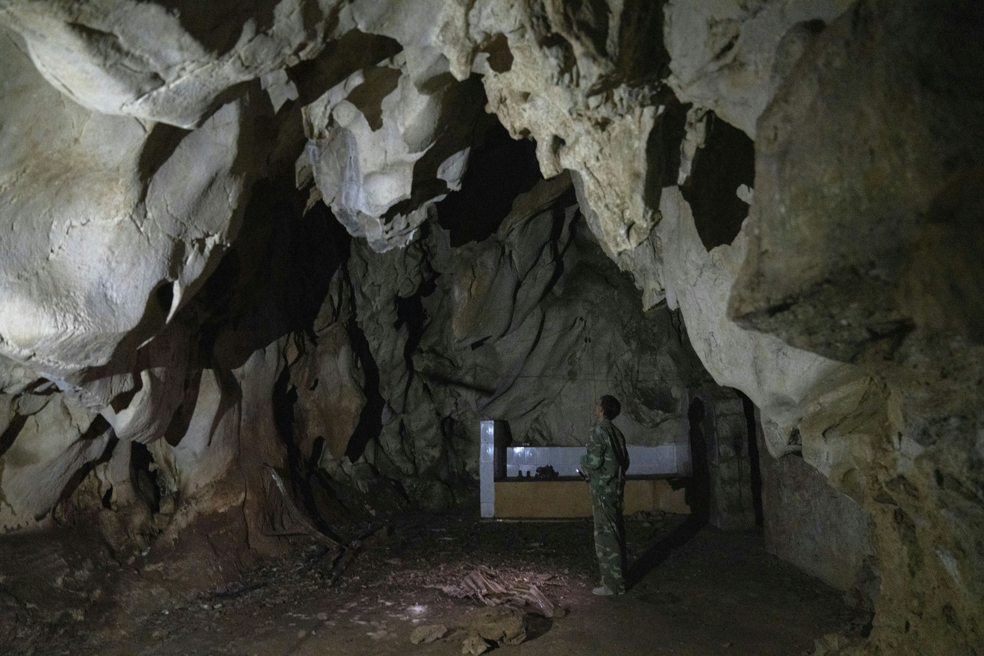 A man stands inside the abandoned Wanling cave near Manhaguo village in southern China's Yunnan province on Wednesday, Dec. 2, 2020. Villagers said the cave had been used as a sacred altar presided over by a Buddhist monk _ precisely the kind of contact between bats and people that alarms scientists. (AP Photo/Ng Han Guan)