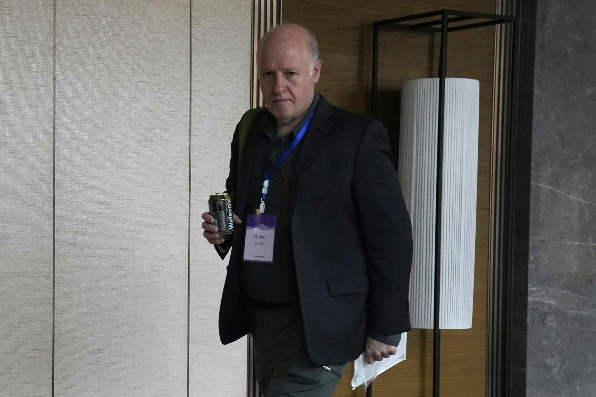 Peter Daszak of the World Health Organization team, walks to a conference center in the cordoned off wing of the hotel in Wuhan in central China's Hubei province on Monday, Feb. 8, 2021. (AP Photo/Ng Han Guan)