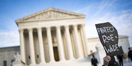A demonstrator holds a “Protect Roe v. Wade” sign outside the U.S. Supreme Court in Washington, D.C., on Dec. 1, 2021.
