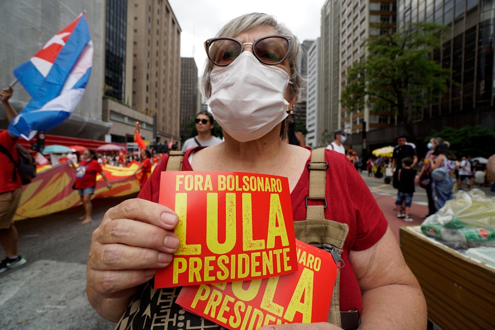 Supporters of former President Luis Inacio Lula da Silva take part in a protest on Paulista Avenue calling for the impeachment of President Jair Bolsonaro on December 12, 2021. (Photo by Cris Faga/NurPhoto via Getty Images)