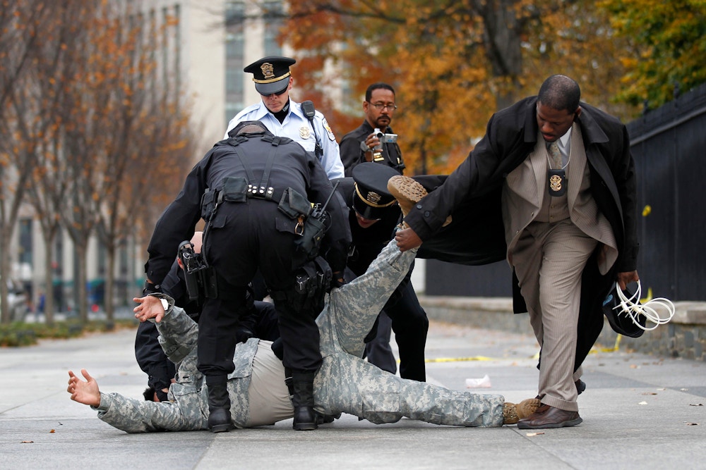 Lt. Dan Choi, is flipped over by law enforcement officers as he is arrested for handcuffing himself to the fence outside the White House  in Washington, Monday, Nov. 15, 2010, during a protest for military gay-rights. The group demanded that President Obama keep his promise to repeal 'Don't Ask, Don't Tell.(AP Photo/Pablo Martinez Monsivais)