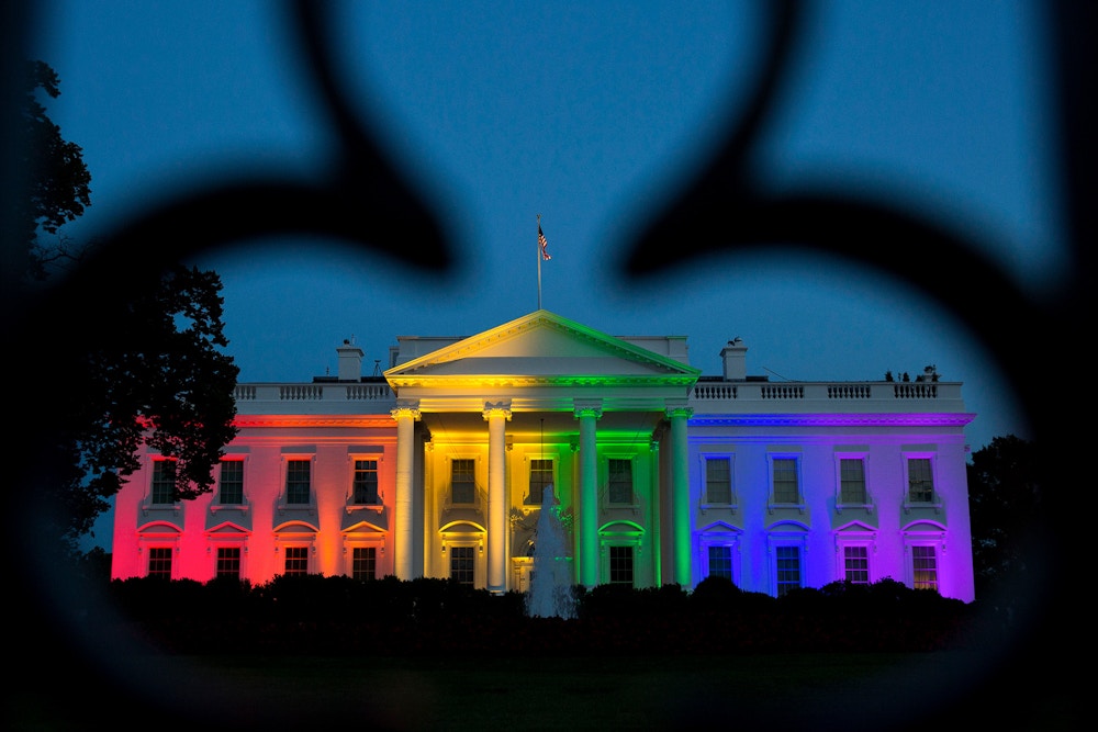The White House stands illuminated in rainbow colored light at dusk in Washington, D.C., U.S., on Friday, June 26, 2015. The Supreme Court's ruling that gay marriage is legal nationwide is a "victory for America," U.S. President Barack Obama said today, declaring that justice had arrived for same-sex couples with "a thunderbolt." Photographer: Drew Angerer/Bloomberg via Getty Images