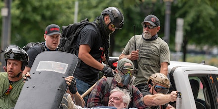 Far-right extremists leave Portland, Ore., after clashing with antifascists on Aug. 7, 2021.
