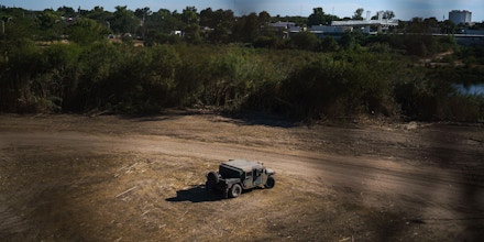 A United States National Guard Humvee is parked in the area where the encampment of about 15,000 Haitians was located only days before, under the Del Rio Port of Entry, which reopened after being closed for more than a week in Del Rio, Texas, on September, 25, 2021. - Almost all of the mostly Haitian migrants who had gathered on both sides of the US-Mexico border have left their makeshift camps, ending a standoff that had provoked a major border crisis for the Biden administration. (Photo by PAUL RATJE / AFP) (Photo by PAUL RATJE/AFP via Getty Images)