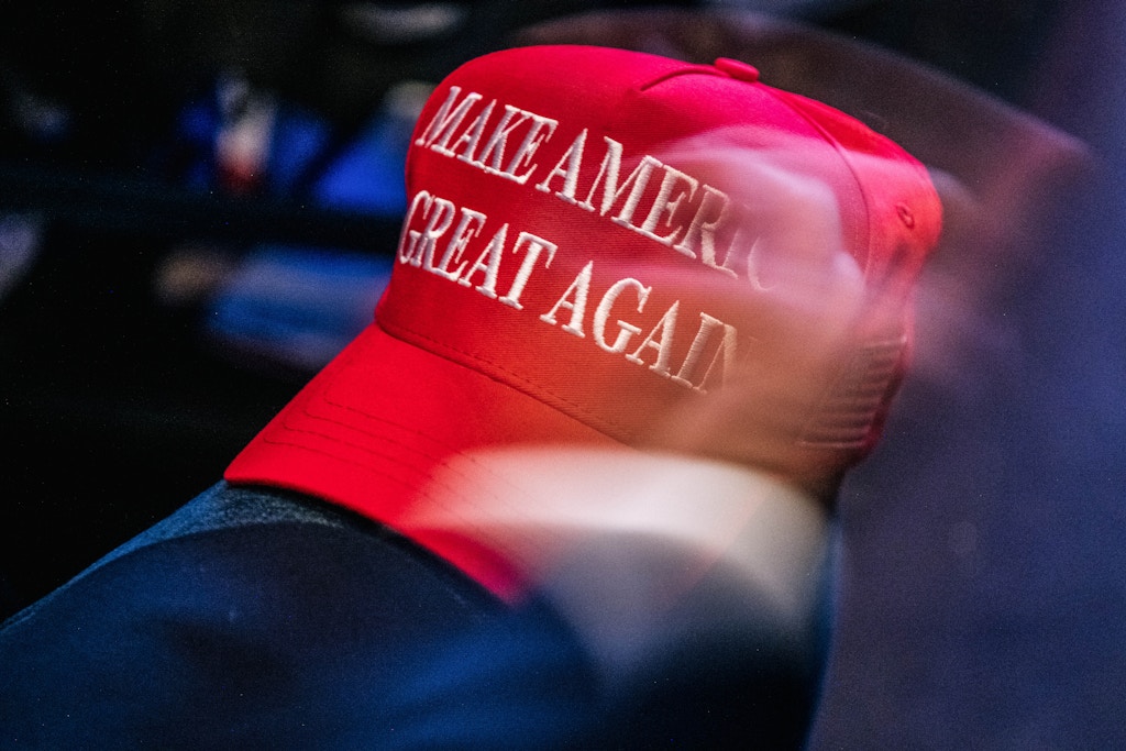 PHOENIX, ARIZONA - JULY 24: A 'Make America Great Again baseball cap rests on the knee of a person at the Rally To Protect Our Elections conference on July 24, 2021 in Phoenix, Arizona. The Phoenix-based political organization Turning Point Action hosted former President Donald Trump alongside GOP Arizona candidates who have begun candidacy for government elected roles. (Photo by Brandon Bell/Getty Images)