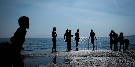 Afghan youth from Kunduz bathe while waiting with other recently arrived migrants to board a ferry to Athens from Mytilene, Greece on October 16, 2015.