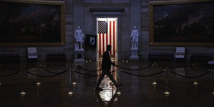 WASHINGTON, DC - MARCH 24:  A man walks through the U.S. Capitol Rotunda, empty of tourists as only essential staff and journalists are allowed to work during the coronavirus pandemic March 24, 2020 in Washington, DC. After days of tense negotiations -- and Democrats twice blocking the nearly $2 trillion package -- the Senate and Treasury Department appear to have reached important compromises on legislation to shore up the economy during the COVID-19 pandemic. (Photo by Chip Somodevilla/Getty Images)