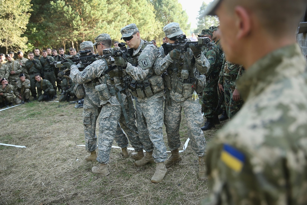 Members of the U.S. Army 173rd Airborne Brigade demonstrate urban warfare techniques as Ukrainian soldiers look on on the second day of the 'Rapid Trident' bilateral military exercises between the United States and Ukraine that include troops from a variety of NATO and non-NATO countries on September 16, 2014 near Yavorov, Ukraine.