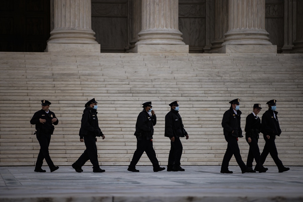 Supreme Court Police officers walk across the plaza in front of the U.S. Supreme Court in Washington, D.C., U.S., on Monday, Nov. 1, 2021. The Texas abortion clash goes before the court today, with providers and the Biden administration trying to cut through a procedural haze to block a law that has largely shut down the practice in the country's second-largest state. Photographer: Samuel Corum/Bloomberg via Getty Images