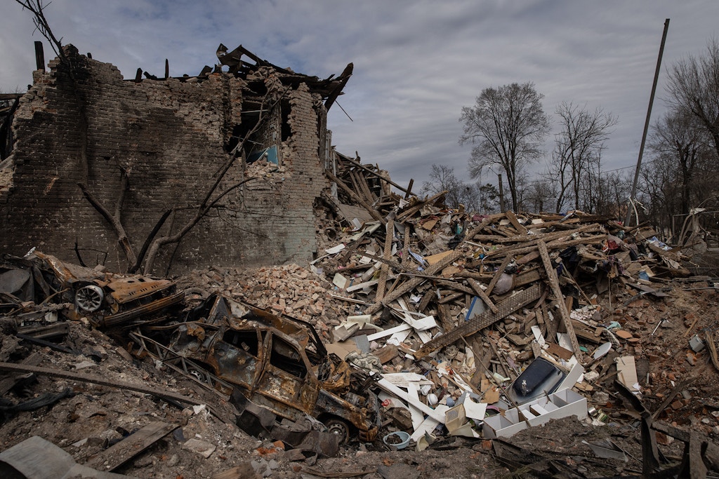 A destroyed car is seen in a crater from a Russian attack that destroyed a house, March 28, 2022 in Kharkiv, Ukraine.