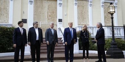 President Donald Trump stands outside St. John's Church across Lafayette Park from the White House Monday, June 1, 2020, in Washington. Part of the church was set on fire during protests on Sunday night. Standing with Trump are Defense Secretary Mark Esper, from left, Attorney General William Barr, White House national security adviser Robert O'Brien, White House press secretary Kayleigh McEnany and White House chief of staff Mark Meadows. (AP Photo/Patrick Semansky)