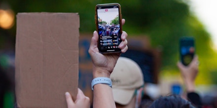 Demonstrators live-stream a protest via smartphones in Uptown neighborhood of Chicago, the United States, June 1, 2020.