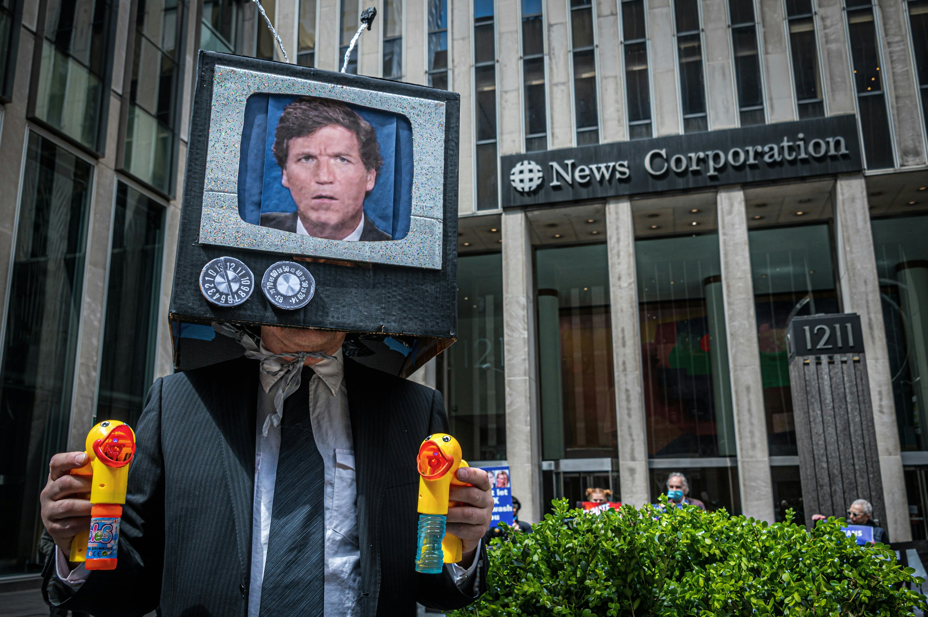 MANHATTAN, NEW YORK, UNITED STATES - 2022/04/19: Participant seen wearing a Tucker Carlson On TV mask at the protest. As part of Earth Week, activists from Rise and Resist, Truth Tuesdays and Extinction Rebellion gathered in the public space in front of Fox Headquarters in Manhattan to protest the network's ongoing propagation of dangerous climate lies. (Photo by Erik McGregor/LightRocket via Getty Images)