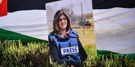 A portrait of Al Jazeera reporter Shireen Abu Akleh wearing her press flack jacket is seen, during a protest of her killing by alleged Israeli gunfire, in front of the Israeli Embassy in Athens, Greece, on May 16, 2022.