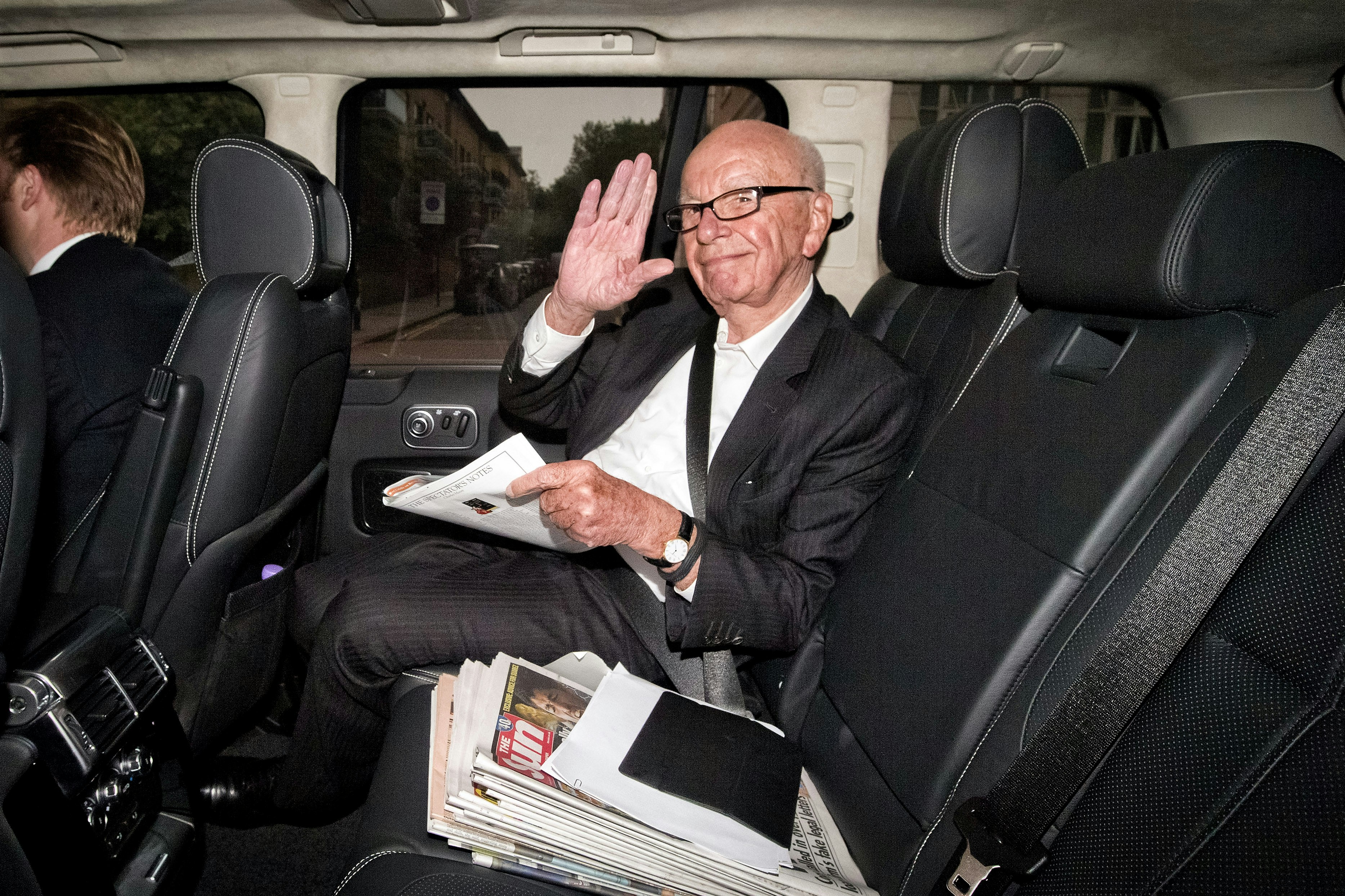 Media Mogul Rupert Murdoch waves to photographers as he is driven away from News UK headquarters in London, on June 26, 2014.  News Corporation executive chairman Rupert Murdoch was in London, where he visited the headquarters of News UK,  after the high-profile trial concluded with the acquittal of his protege Rebekah Brooks and the conviction of Andy Coulson, one of his former British newspaper editors. AFP PHOTO / JUSTIN TALLIS        (Photo credit should read JUSTIN TALLIS/AFP via Getty Images)
