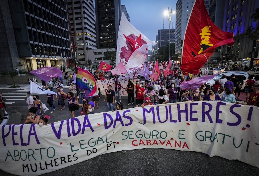 Women march shouting slogans against Brazil's President Jair Bolsonaro and holding a banner in favor of legalizing abortion, to mark International Women's Day in Sao Paulo, Brazil, Tuesday, March 8, 2022. (AP Photo/Andre Penner)