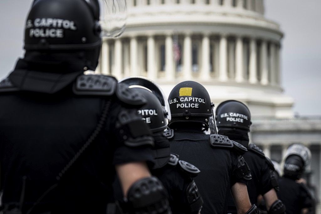 UNITED STATES - JUNE 24: U.S. Capitol Police in riot gear return to their staging area after clear a path back to the Capitol for House Democrats after they spoke in front of the Supreme Court following the Dobbs v Jackson Women's Health Organization decision overturning Roe v Wade was handed down at the U.S. Supreme Court on Friday, June 24, 2022. (Bill Clark/CQ Roll Call via AP Images)