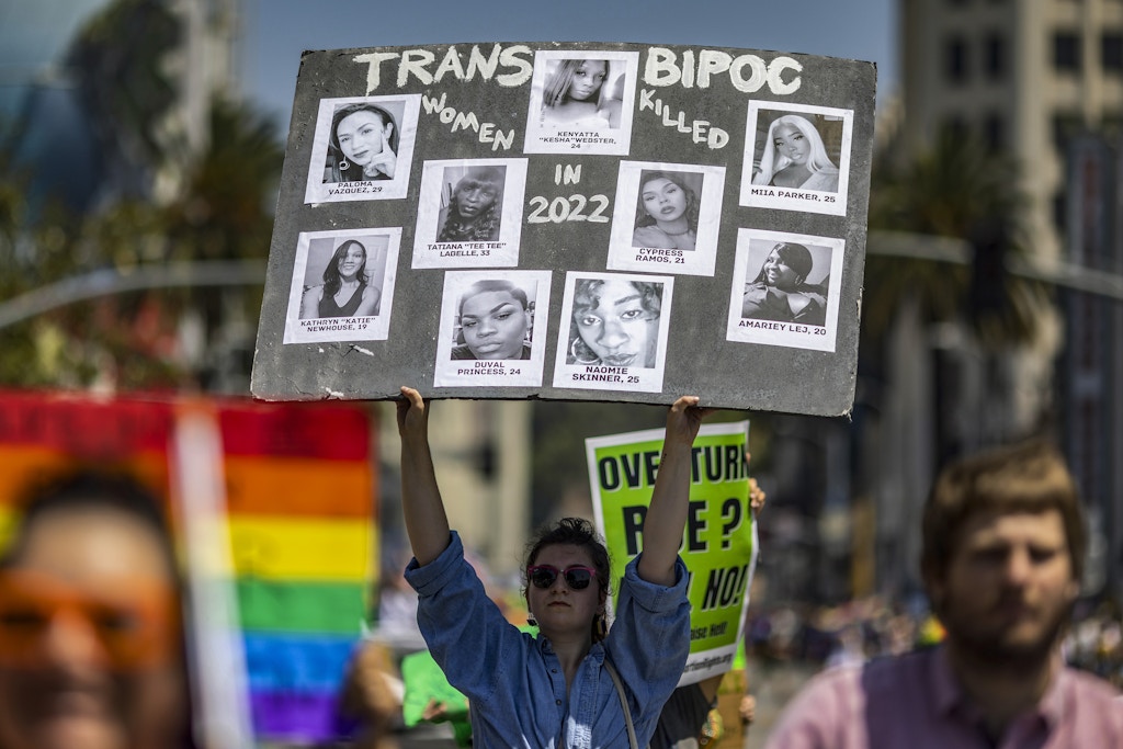 LOS ANGELES, CA - JUNE 12: A participant holds photos of transgender people killed in 2022 at the annual Pride Parade on June 12, 2022 in the Hollywood section of Los Angeles, California. After a two-year hiatus due to the COVID-19 pandemic, the Los Angeles Pride Parade has abandoned its historic route through West Hollywood for a new one through Hollywood. The event was first held on June 28, 1970, exactly one year after the historic Stonewall Rebellion in New York City.  (Photo by David McNew/Getty Images)