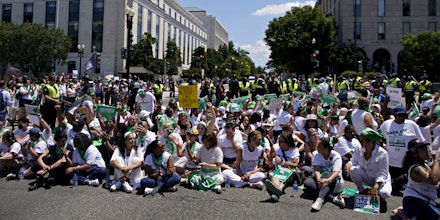 Abortion rights demonstrators block an intersection while sitting in the road during a protest near the US Supreme Court in Washington, D.C., US, on Thursday, June 30, 2022. President Biden today said he would support changing the Senate's filibuster rules to pass legislation ensuring privacy rights and access to abortion, calling the Supreme Court 