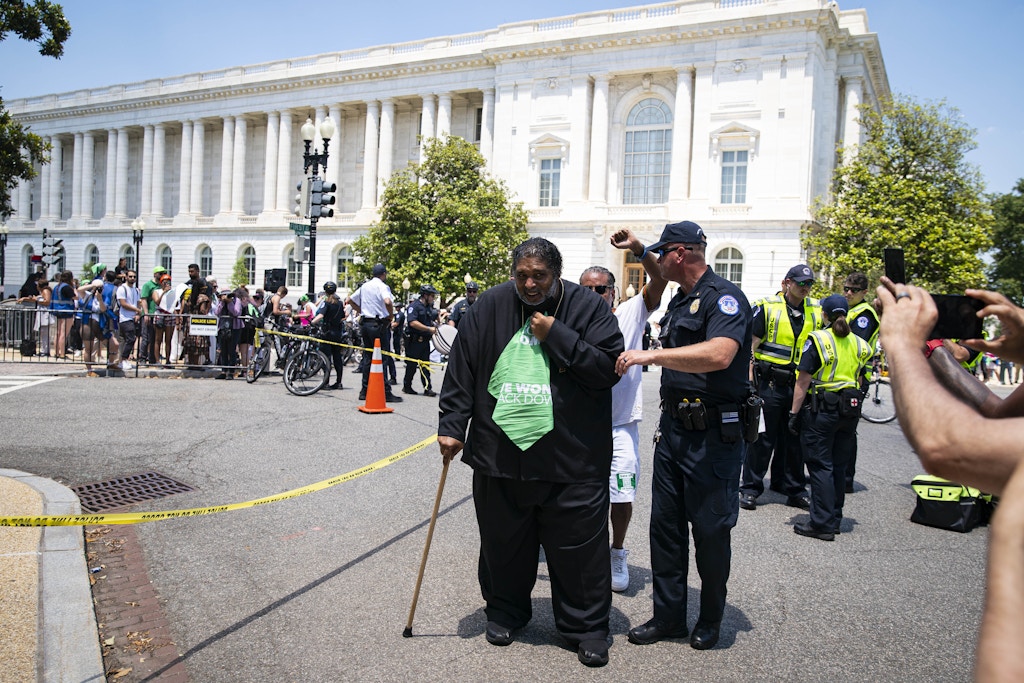 Reverend William Barber II, center, is detained by US Capitol Police for blocking an intersection with abortion rights demonstrators during a protest near the US Supreme Court in Washington, D.C., US, on Thursday, June 30, 2022. President Biden today said he would support changing the Senate's filibuster rules to pass legislation ensuring privacy rights and access to abortion, calling the Supreme Court "destabilizing" for controversial decisions, including overturning Roe v. Wade. Photographer: Al Drago/Bloomberg via Getty Images