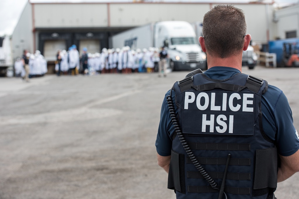 Homeland Security Investigations (HSI) special agent preparing to arrest alleged immigration violators at Fresh Mark, Salem, June 19, 2018. Image courtesy ICE ICE / U.S. Immigration and Customs Enforcement. (Photo by Smith Collection/Gado/Getty Images)