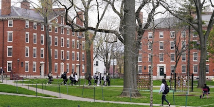 Students walk through Harvard Yard on the campus of Harvard University in Cambridge, Mass., April 27, 2022.