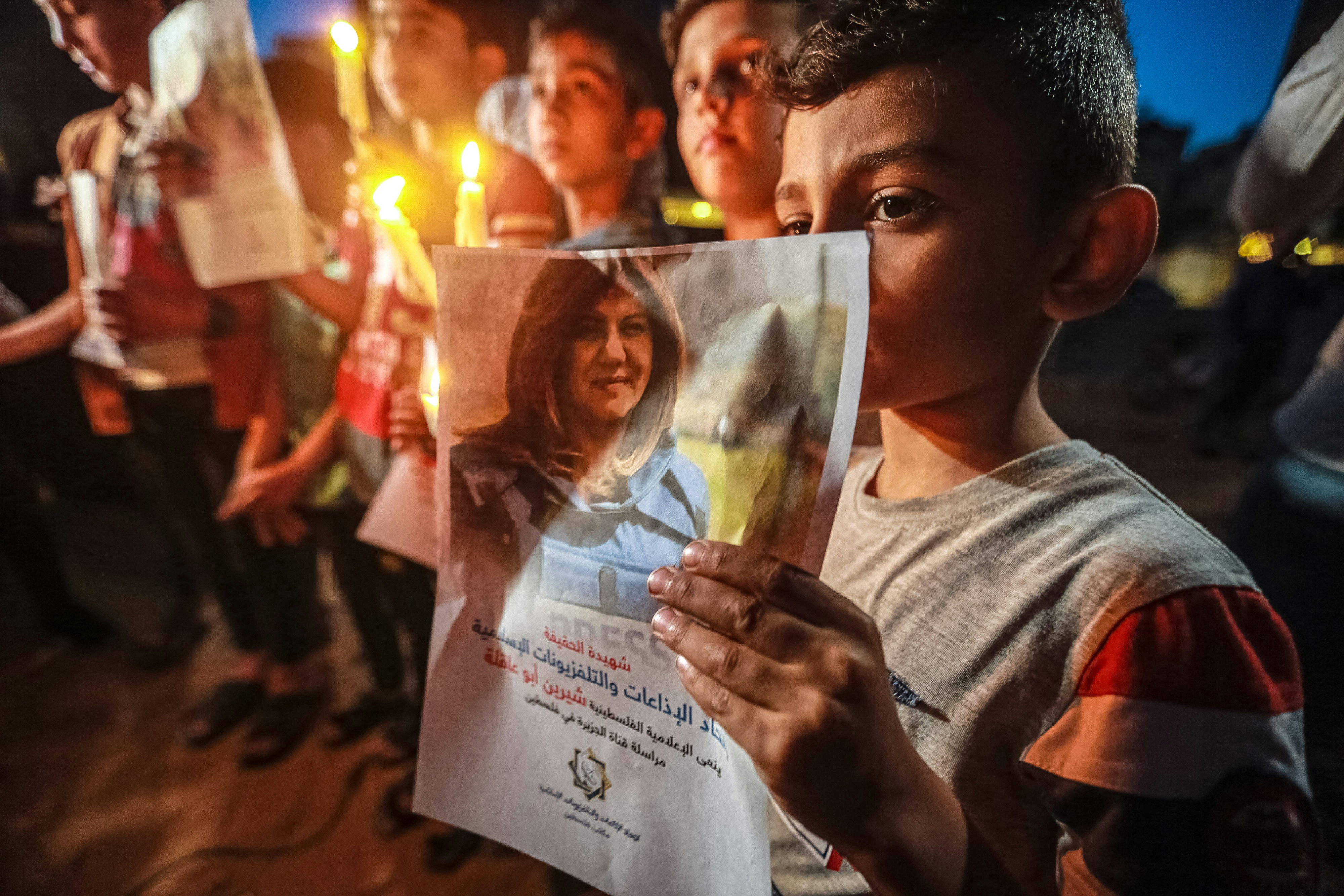 11 May 2022, Palestinian Territories, Gaza City: Children take part in a candlelight vigil to denounce the killing of Al Jazeera reporter Shireen Abu Akleh. Abu Akleh, 51, a prominent figure in the Arabic news service of the Al-Jazeera channel, was shot dead earlier today during a confrontation between Israeli soldiers and Palestinians in the West Bank city of Jenin. Photo: Mohammed Talatene/dpa (Photo by Mohammed Talatene/picture alliance via Getty Images)