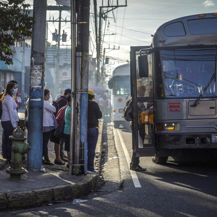 Commuters wait in line to board a bus in San Salvador, El Salvador, on Tuesday, July 19, 2022. El Salvador's gamble on Bitcoin is exacerbating a debt crisis in the financially troubled country, which has been struggling to deal with wide fiscal deficits as an $800 million bond comes due in January. Photographer: Camilo Freedman/Bloomberg via Getty Images