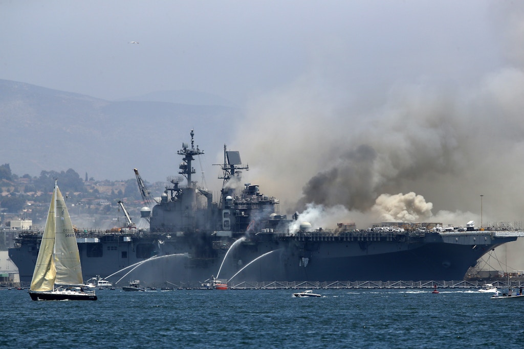 SAN DIEGO, CALIFORNIA - JULY 12:  A fire burns on the amphibious assault ship USS Bonhomme Richard at Naval Base San Diego on July 12, 2020 in San Diego, California. There was an explosion on board the ship with multiple injuries reported.  (Photo by Sean M. Haffey/Getty Images)