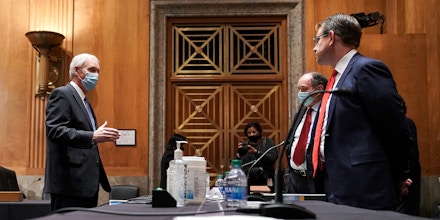 WASHINGTON, DC - DECEMBER 16: Sen. Rick Scott (R-FL) (2nd-L) and Senate Homeland Security and Governmental Affairs Committee Chairman Ron Johnson (R-WI) (L) speak to Trump campaign attorneys James Troupis and Jesse Binnall before a Senate Homeland Security and Governmental Affairs Committee hearing to discuss election security and the 2020 election process on December 16, 2020 in Washington, DC. U.S. President Donald Trump continues to push baseless claims of voter fraud during the presidential election, which Krebs called the most secure in American history.  (Photo by Greg Nash-Pool/Getty Images)