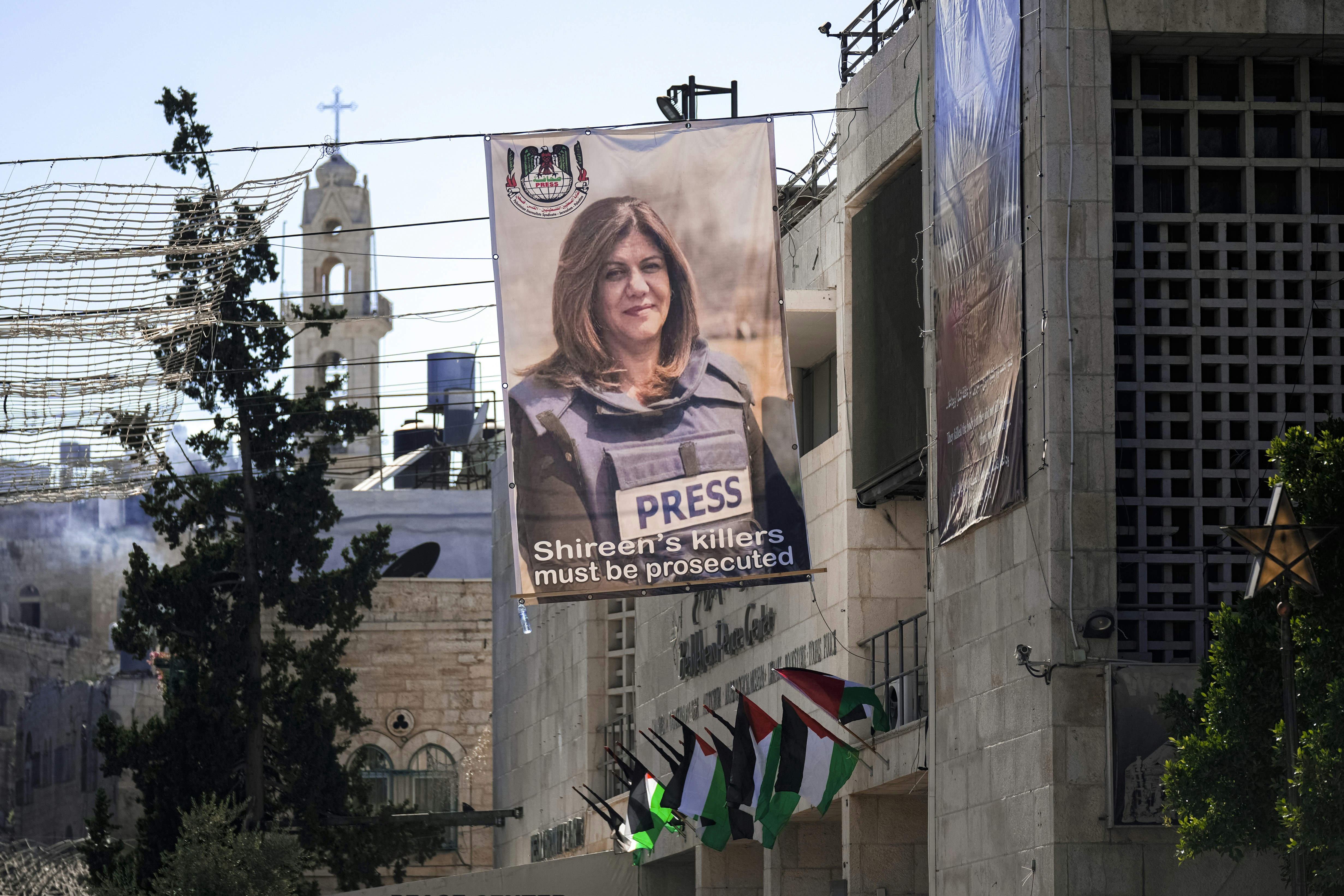 Banners with pictures of the slain Palestinian-American journalist Shireen Abu Akleh are displayed on the Bethlehem Peace Center, ahead of the visit of U.S. President Joe Biden to the West Bank, near the Church of the Nativity, traditionally believed to be the birthplace of Jesus Christ, in the West Bank town of Bethlehem, Thursday, July 14, 2022. On Friday Biden will meet with Palestinian President Mahmoud Abbas in Bethlehem. (AP Photo/Majdi Mohammed)