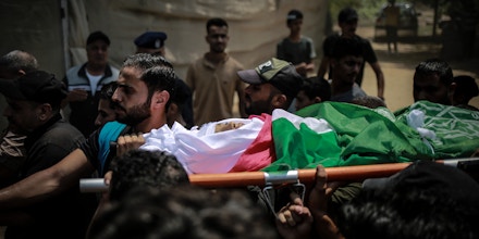 A child killed in the Israeli bombing of Gaza is carried during the funeral in Gaza City on Aug. 8, 2022. 