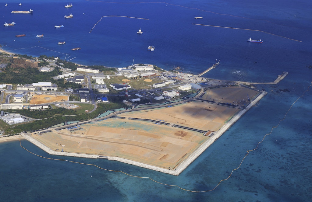 An aerial photo shows a landfill work at a coastal area of Henoko in Nago City, Okinawa Prefecture on December 10, 2021. Henoko has been chosen as the relocation of U.S. Futenma Air Base, nearly 33-hectare section of waters surrounded by seawalls south of U.S. Marine Corps Camp Schwab in the region although more than eighty per cent of the Okinawan opposed to the relocation plan. ( The Yomiuri Shimbun via AP Images )