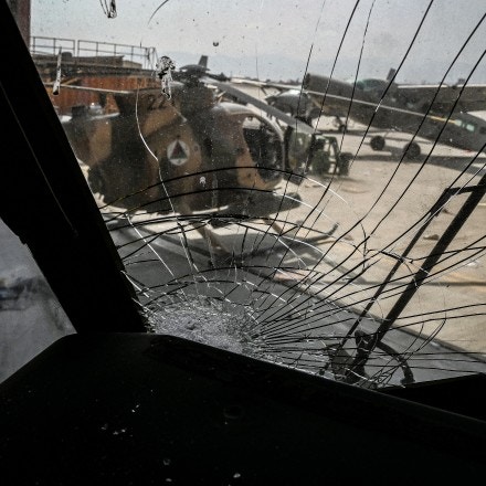 An Afghan Air Force helicopter is pictured through the shattered glass of another aircraft near a hangar at the airport in Kabul on August 31, 2021, after the US pulled all its troops out of the country to end a brutal 20-year war -- one that started and ended with the hardline Islamist in power. (Photo by WAKIL KOHSAR / AFP) (Photo by WAKIL KOHSAR/AFP via Getty Images)