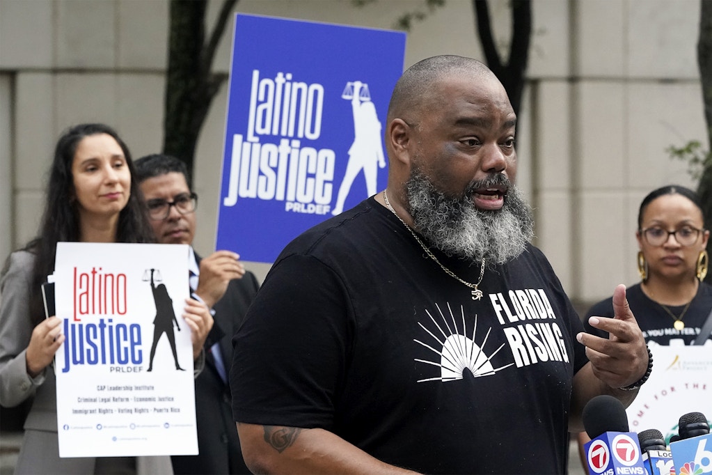 Joined by members of civil rights and voting rights groups, Fla. Sen. Dwight Bullard, foreground, speaks during a news conference, Thursday, Sept. 15, 2022, in front of the James Lawrence King Federal Justice Building in downtown Miami. The coalition said that the State of Florida appealed the United States District Court for the Northern District of Florida's decision striking down provisions of SB90 that would make it harder to access secure ballot drop boxes, deter third-party voter regis­tra­tion organizations from registering people to vote, and restrict the abil­ity to provide food and water to voters wait­ing in long lines on Election Day. (AP Photo/Wilfredo Lee)