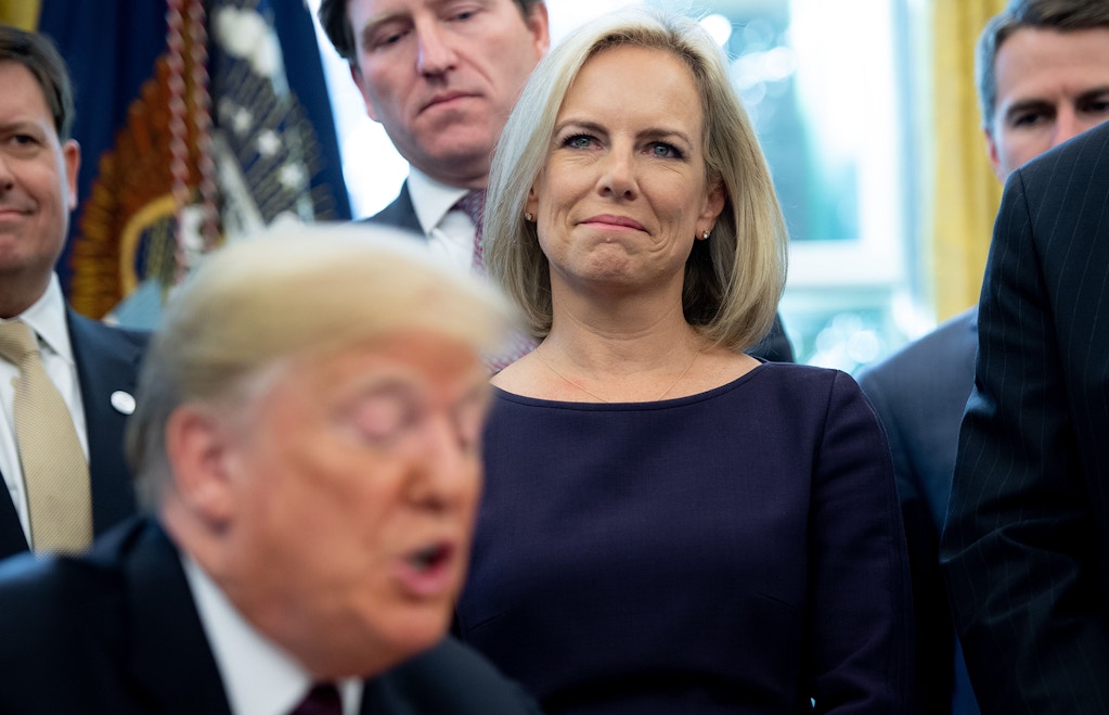 US Secretary of Homeland Security Kirstjen Nielsen stands alongside US President Donald Trump as he speaks prior to signing the Cybersecurity and Infrastructure Security Agency Act in the Oval Office of the White House in Washington, DC, November 16, 2018. - The act creates the Cybersecurity and Infrastructure Security Agency (CISA). (Photo by SAUL LOEB / AFP)        (Photo credit should read SAUL LOEB/AFP via Getty Images)