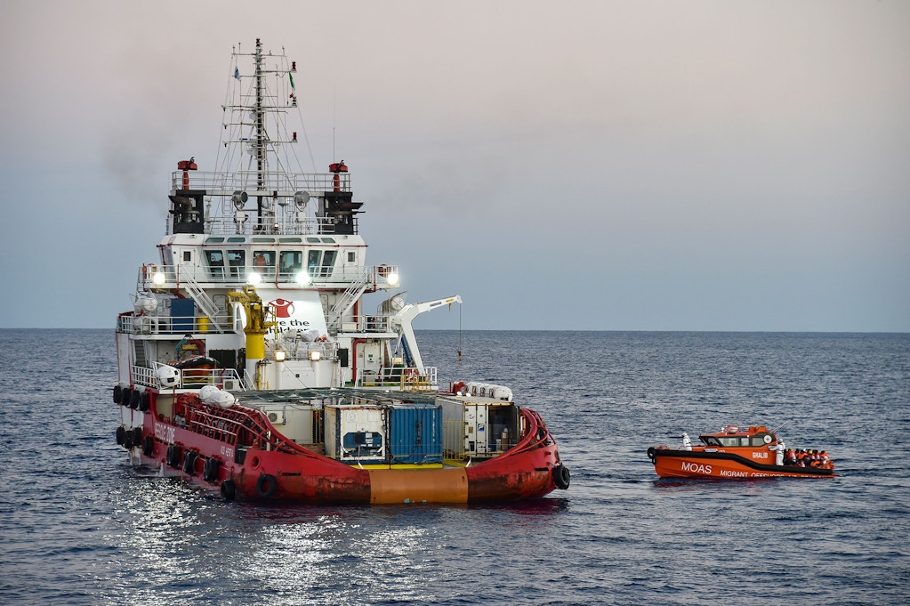 Migrants and refugees are transferred from the Topaz Responder ship run by Maltese NGO "Moas" and the Italian Red Cross to the Vos Hestia ship run by NGO "Save the Children", on November 4, 2016, a day after a rescue operation off the Libyan coast in the Mediterranean Sea.