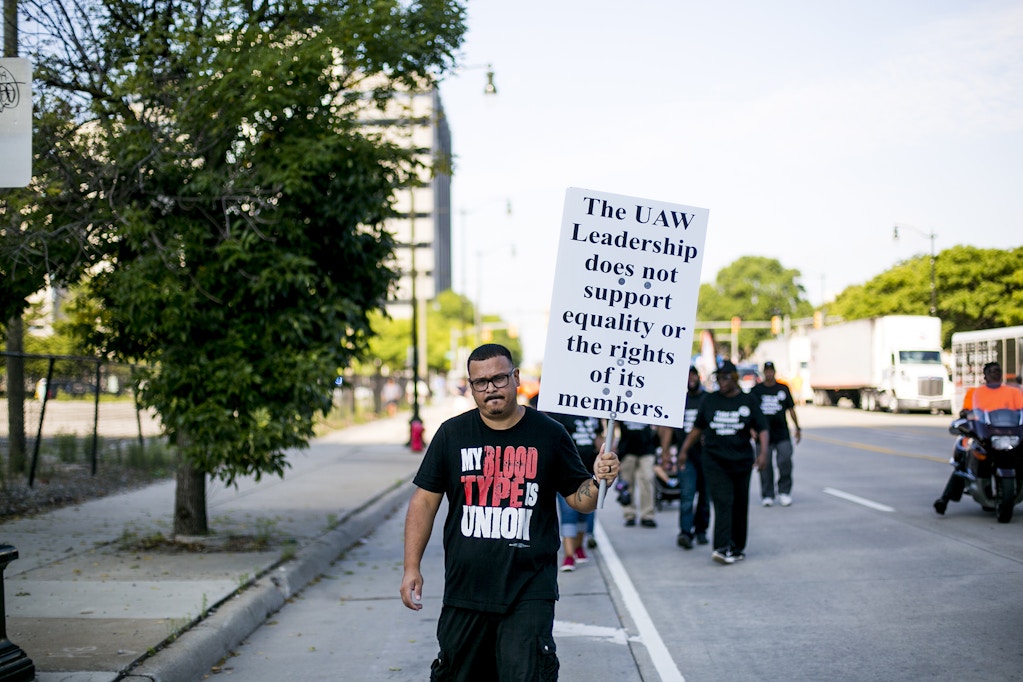 A United Auto Workers (UAW) member holds a sign reading "The UAW Leadership does not support equality or the rights of its members" during a protest at a Labor Day parade in Detroit, Michigan, U.S., on Monday, Sept. 2, 2019. General Motors Co. now employs fewer union-represented American workers than its domestic rivals for the first time since the United Auto Workers started organizing Detroit's carmakers eight decades ago. Photographer: Anthony Lanzilote/Bloomberg via Getty Images