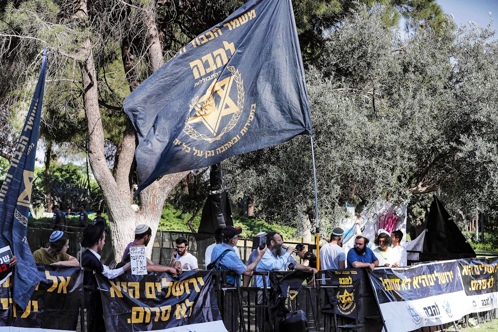 Israeli right-wing demonstrators gathering with the flag of the far-right Jewish group "Lehava" (Flame) and banners reading in Hebrew "Jerusalem is not Sodom" (referring to the legendary biblical city destroyed by God for wickedness), during a protest against the annual Jerusalem Pride Parade, in Jerusalem on June 2, 2022. (Photo by Ahmad GHARABLI / AFP) (Photo by AHMAD GHARABLI/AFP via Getty Images)