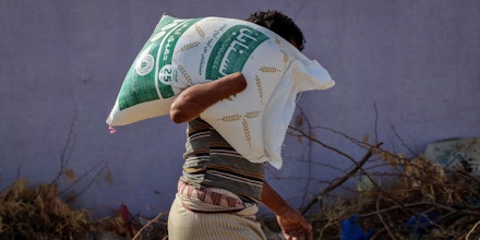 Yemenis displaced by conflict receive food aid and supplies to meet their basic needs, at a camp for displaced people in the al-Khoukha directorate, in Yemen's war-ravaged western province of Hodeida, on October 19, 2022. (Photo by Khaled Ziad / AFP) (Photo by KHALED ZIAD/AFP via Getty Images)