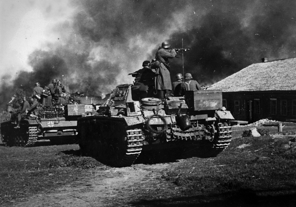 German tanks advance against Soviet settlements in October 1941.